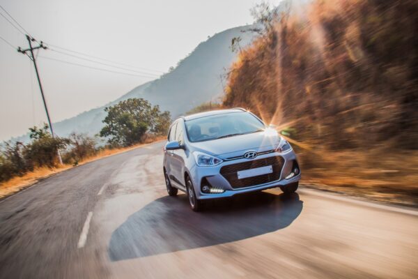 silver car driving on a road